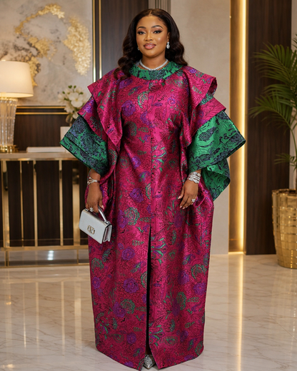A regal magenta and emerald luxury African boubou featuring bold print detailing, statement layered sleeves, and a flowing maxi silhouette. Perfect for weddings, birthdays, owambe parties, church, Eid, and elegant cultural celebrations.