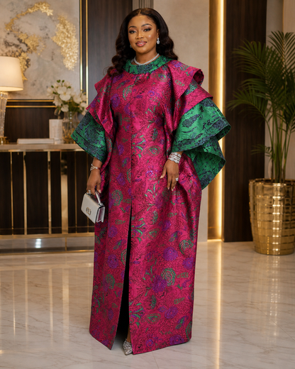 Woman in a vibrant, patterned dress standing in an elegant interior setting.